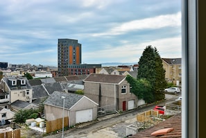 A residential area with houses, a tall building, and a street.