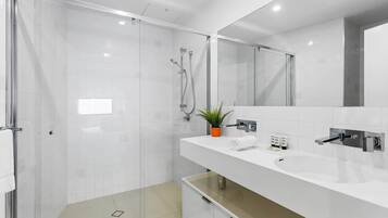 Bathtub, hair dryer, towels, shampoo