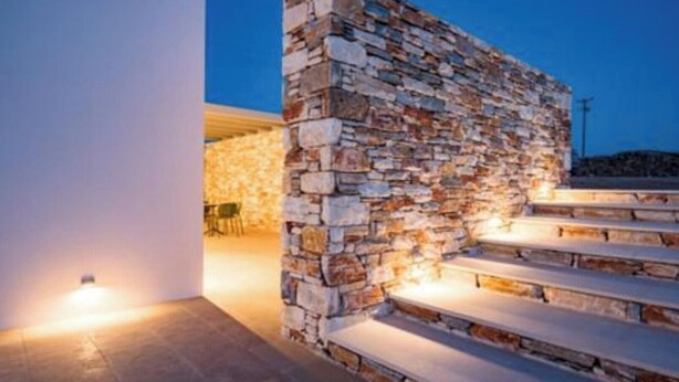 A stone staircase leading to a covered outdoor area with a seating arrangement. - Bracket House Paros Villa with Private Pool Sleeps 8 (Paros)