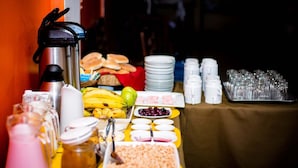 A buffet table with various food items, including fruits, condiments, and beverages. - Sol de los Andes Machupicchu (Machu Picchu)