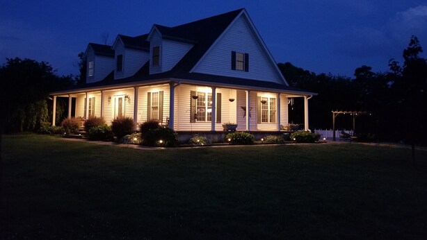 A two-story house with a porch and a covered front porch area.