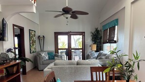 A spacious living area with a ceiling fan, a dining table, and a sofa set. - 10% OFF ON STAYS OF 7 NIGHTS OR MORE ! AMAZING BEACHFRONT PROPERTY.. (San Pedro)
