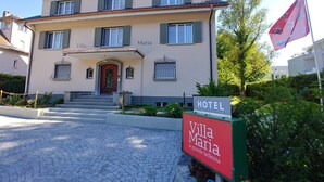 A two-story building with a sign reading "Villa Maria HOTEL." - Villa Maria (Lucerne)