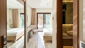 A hotel room with a large mirror, a bed, a desk, and a bathroom with a marble floor. - Dna Hotel Dalyan Adult Only (Ortaca)