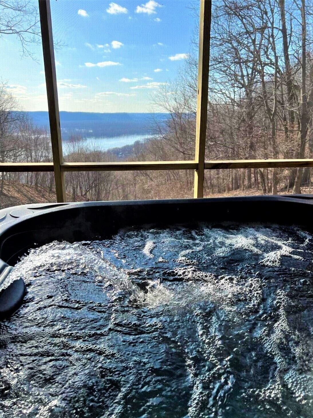 Hot tub in screen porch just outside of lower level family room