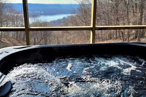 Hot tub in screen porch just outside of lower level family room