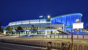A modern building with a prominent McDonald's sign, large glass windows, and a curved facade. - Live and Stay - Ekmanska (Gothenburg)