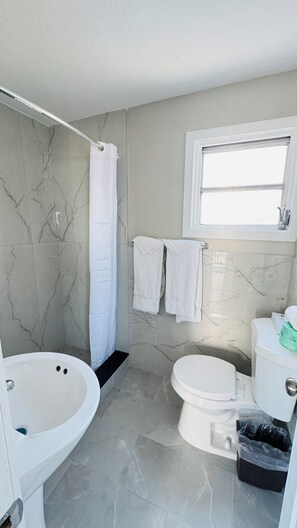 Deluxe tweepersoonskamer, meerdere bedden | Badkamer | Een bad, gratis toiletartikelen, handdoeken