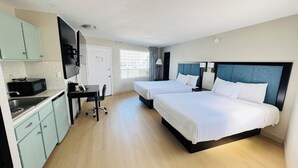 A hotel room with two beds, a desk, a microwave, and a kitchenette. - Bel Air Motel (Wildwood Crest)