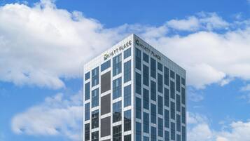 A modern hotel building with a glass facade and the name 'Hyatt Place' on the top.