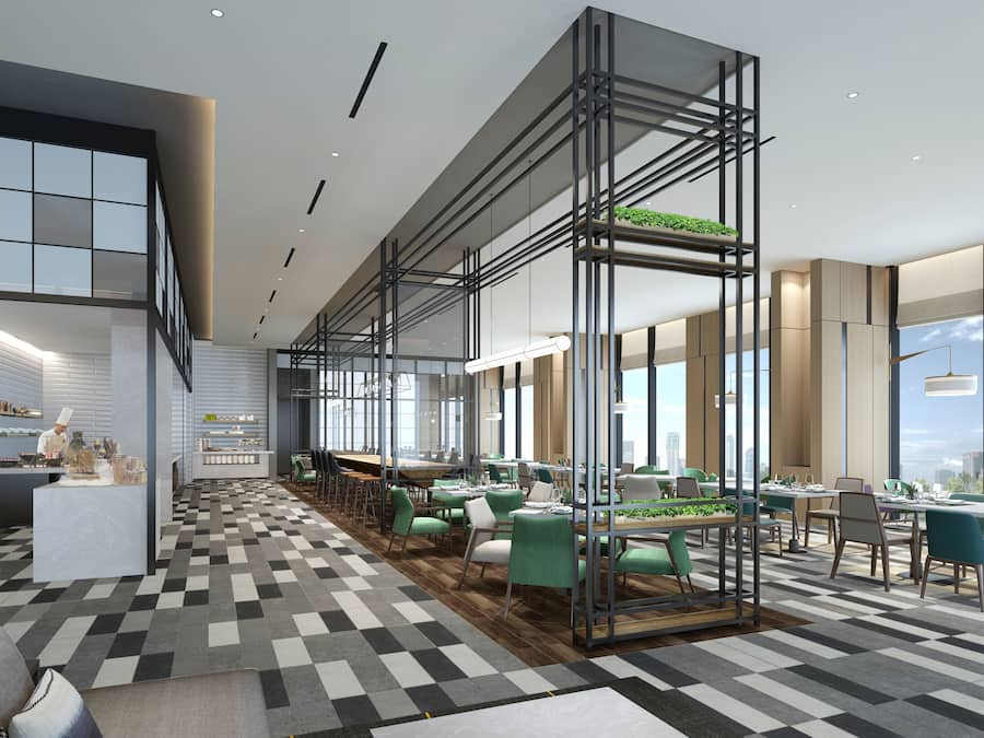 A modern dining area with a checkered floor, green and white chairs, and a central pool table.