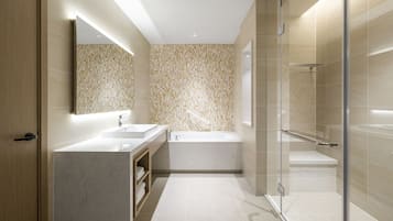A modern bathroom with a large mirror, two sinks, a bathtub, and a glass-enclosed shower area.