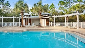 A swimming pool with lounge chairs and a covered area with a pergola. - Anchor House- Heated Pool- 4 Bikes!- Prime Beach A (Santa Rosa Beach)