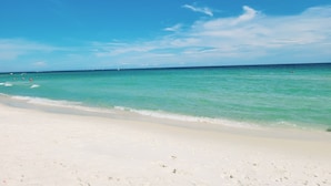 A beach with clear turquoise water and a white sandy shore. - Bella Luna 1009-Luxury Condo-Great Views-Walk to Flora-Bama-Boaters Heaven! (Orange Beach)