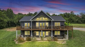 A two-story house with a balcony, a front porch, and a well-maintained lawn. - Serenity on Siverly: Saltwater pool and amazing view (McArthur)