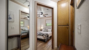 A bedroom with a bed, bedside table, and a ceiling fan. - Deer Crossing Cabin Cabin in heart of Hochatown, 259, Broken Bow Lake (Broken Bow)
