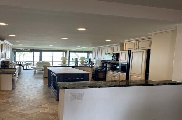 A spacious kitchen with modern appliances, ample counter space, and a view to the living area.