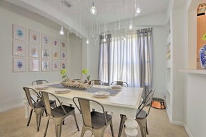 A dining area with a large table, chairs, and a decorative centerpiece.