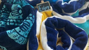 A basket of folded blankets in various colors. - Catch n' Relax Anglers Ultimate Waterfront Retreat with 50’ Dock Modern New Home (Marathon)