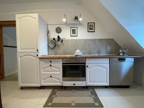 Fridge, stovetop, dishwasher, coffee/tea maker