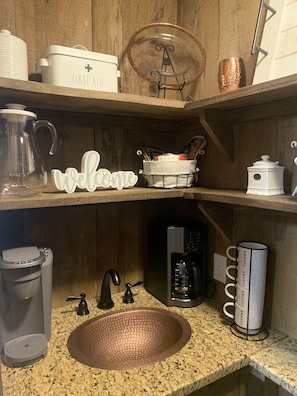 Enjoy a warm welcome in this inviting kitchen, equipped with a coffee maker, kettle, and everything you need to start your day.