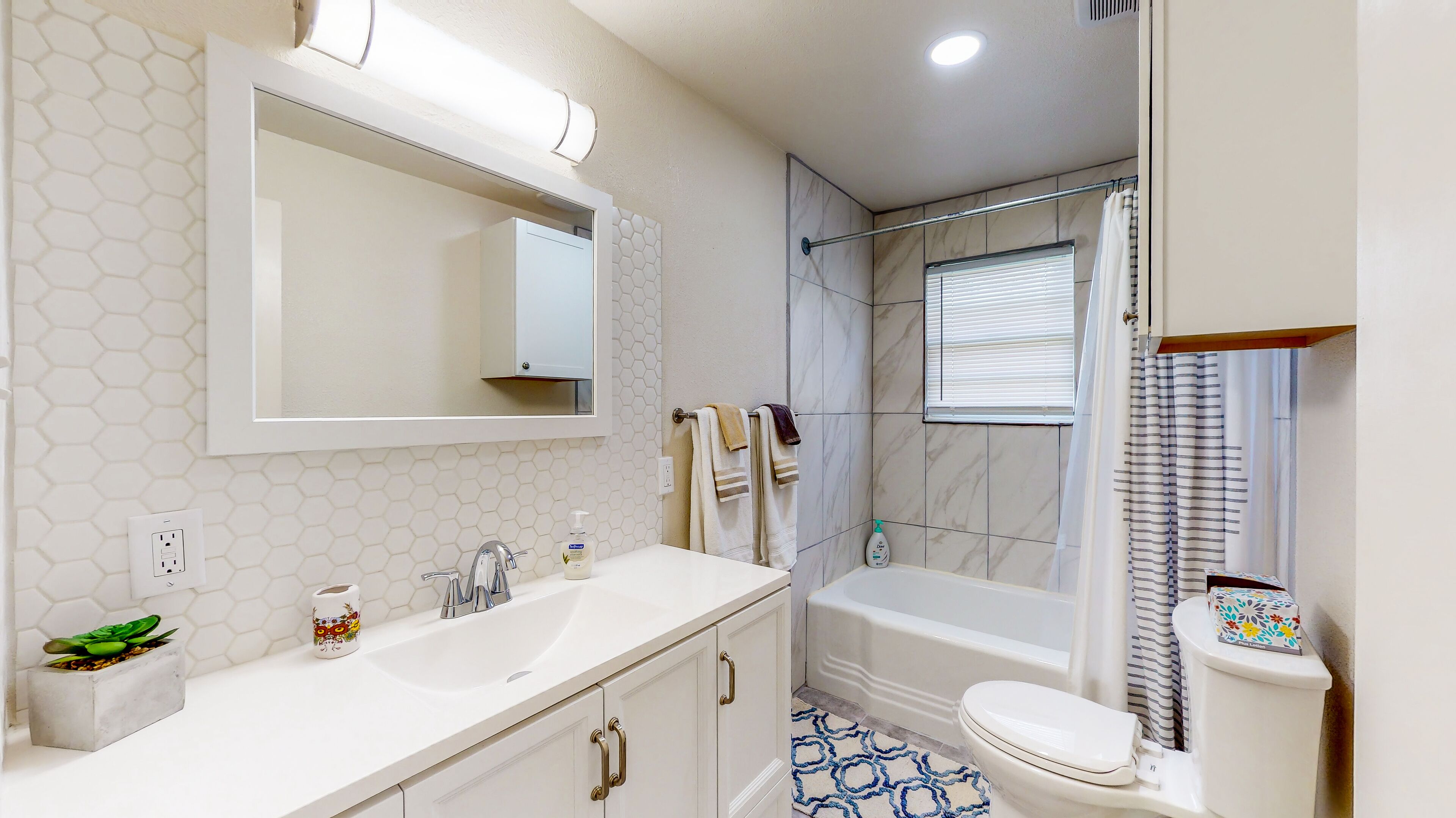 Combined shower/tub, hair dryer, towels, soap