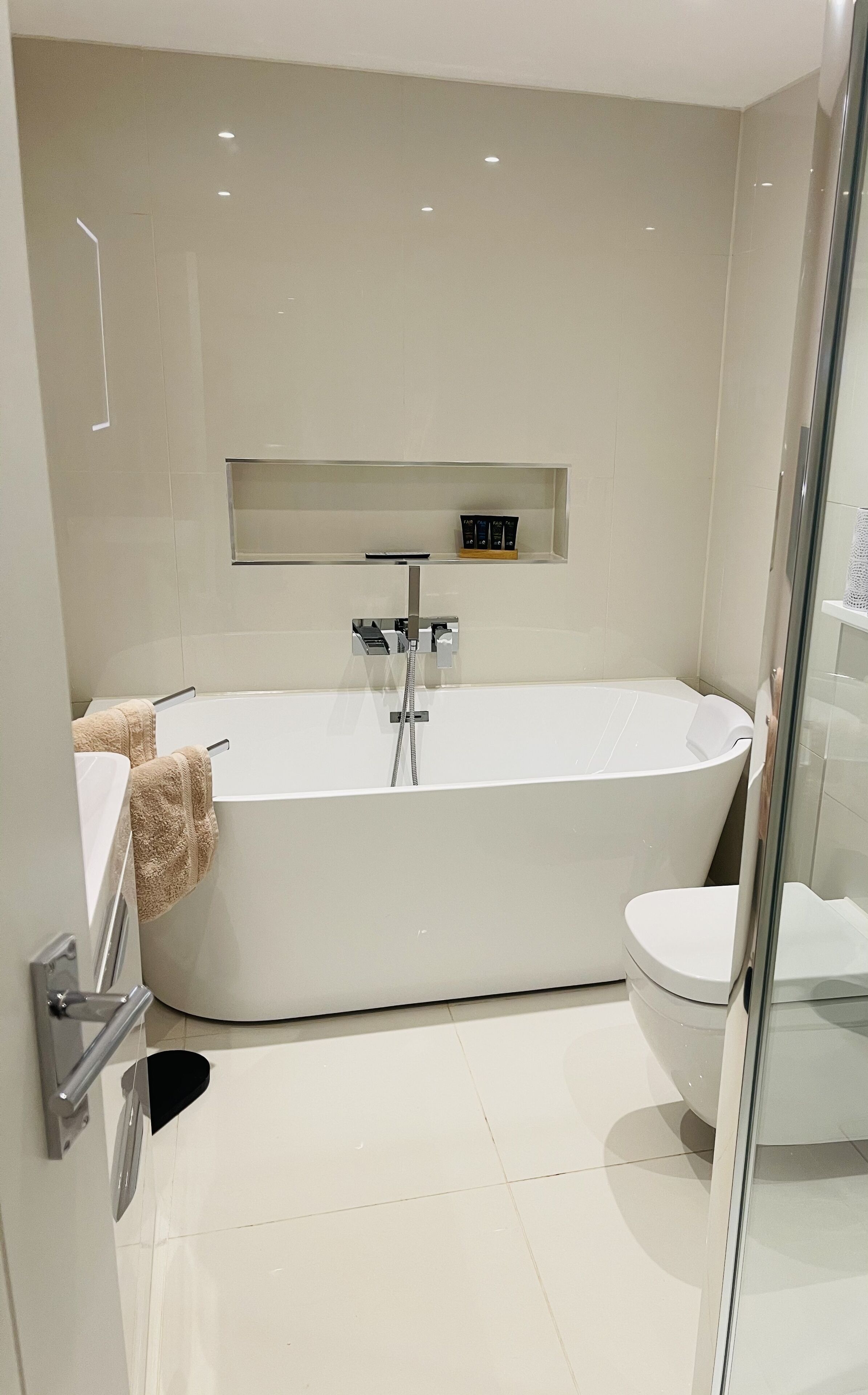 Bathtub, hair dryer, towels, soap