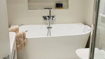 Bathtub, hair dryer, towels, soap