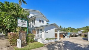 A two-story building with a sign reading "Cocos Holiday Apartments." - Cocos Holiday Apartments (Trinity Beach)