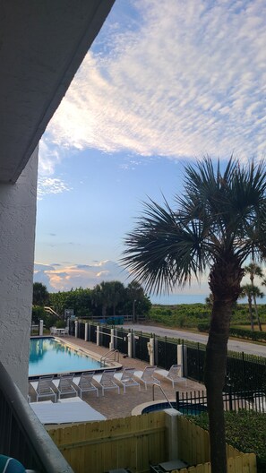 Outdoor pool, a heated pool - Oceanfront Condo w/ ocean view private balcony, on-site heated pool & hot tub (Cape Canaveral)
