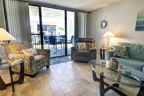 Relax in a comfortable living space with a balcony offering views of the surrounding area.