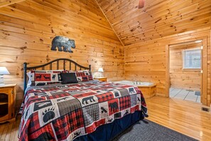 A wooden cabin bedroom with a bed, a nightstand, a window, and a wooden ceiling. - 1BR Cozy Cabin - Romantic, Hot Tub, Couples, RELAX in Pigeon Forge (Pigeon Forge)