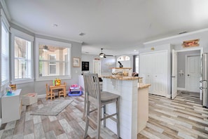 Enjoy meals in this well-lit kitchen with an oven and refrigerator, and dine at the wooden table.