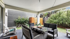 A covered patio with a dining table, chairs, and a hammock. - Stunning Sea Views in Excellent Location (Victor Harbor)