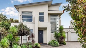 A modern two-story building with a flat roof, large windows, and a dark front door. - Stunning Sea Views in Excellent Location (Victor Harbor)
