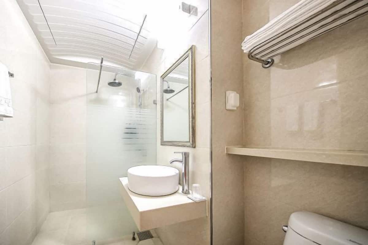 Shower, hair dryer, slippers, towels