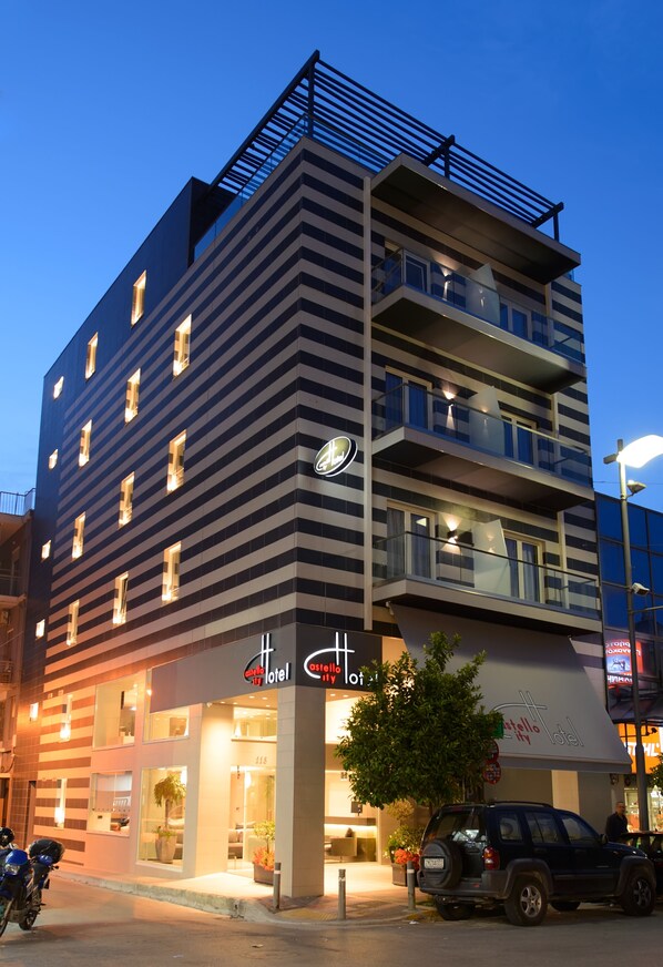 A multi-story hotel with a modern design, featuring balconies and large windows.
