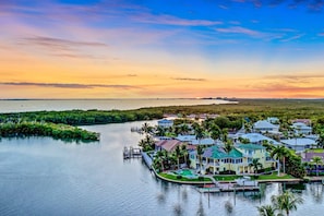 A waterfront property with multiple houses, docks, and a marina.