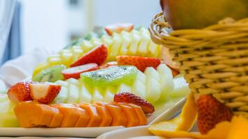 A fruit platter with various fruits including strawberries, kiwi, and mango.