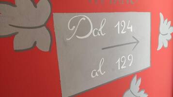 A directional sign with 'Dcl 124' and 'al 129' indicating room numbers.