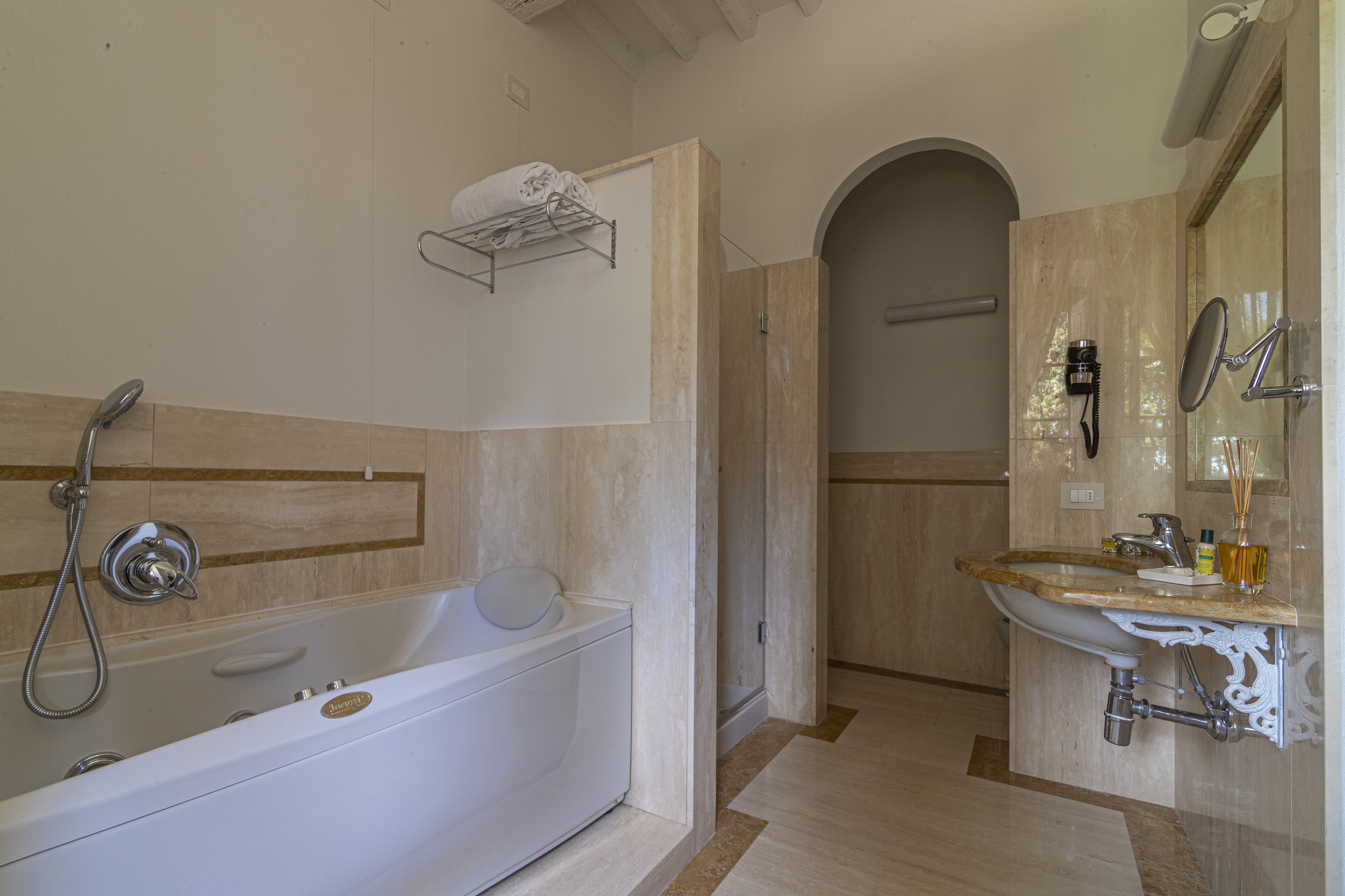 A modern bathroom with a freestanding bathtub, a sink with a decorative basin, and a towel rack.