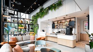 A modern interior with a seating area, a bar, and a kitchen.