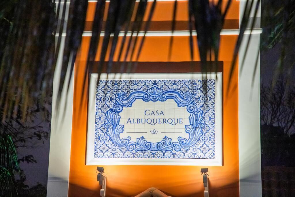 A framed sign with 'Casa Albuquerque' text, surrounded by ornate blue patterns.