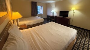 A hotel room with two beds, a desk, a television, and a window with curtains. - Norwood Inn & Suites by BlissPoint Post Rd Indianapolis (Indianapolis)