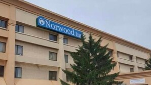 A multi-story building with a sign that reads "Norwood Inn." - Norwood Inn & Suites by BlissPoint Post Rd Indianapolis (Indianapolis)