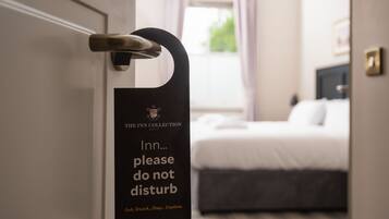 A hotel room door with a sign that reads "The Inn Collection please do not disturb."