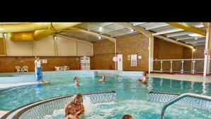 An indoor swimming pool with multiple lanes and a central hot tub area. - The Sea Breeze - Captivating Caravan in Camber (Rye)