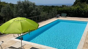 A rectangular swimming pool with a clear blue water surface, surrounded by a tiled deck. - Casa Sophia, pool with sea view - garden, barbecue and parking are pri (Guardistallo)