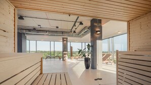 A modern interior with wooden flooring, large windows, and a view of the outdoors. - Q Hotel Plus Wrocław Bielany (Kobierzyce)