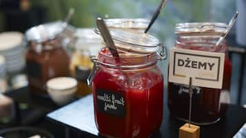 A display of multi-berry jams with labels indicating flavors like 'multi fruit jam' and 'Dźemy jams'.
